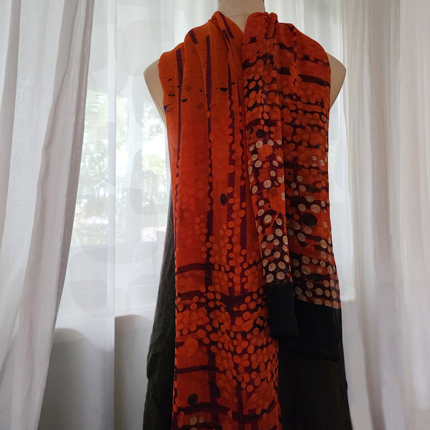 Silk scarf in shades of red, black and white.