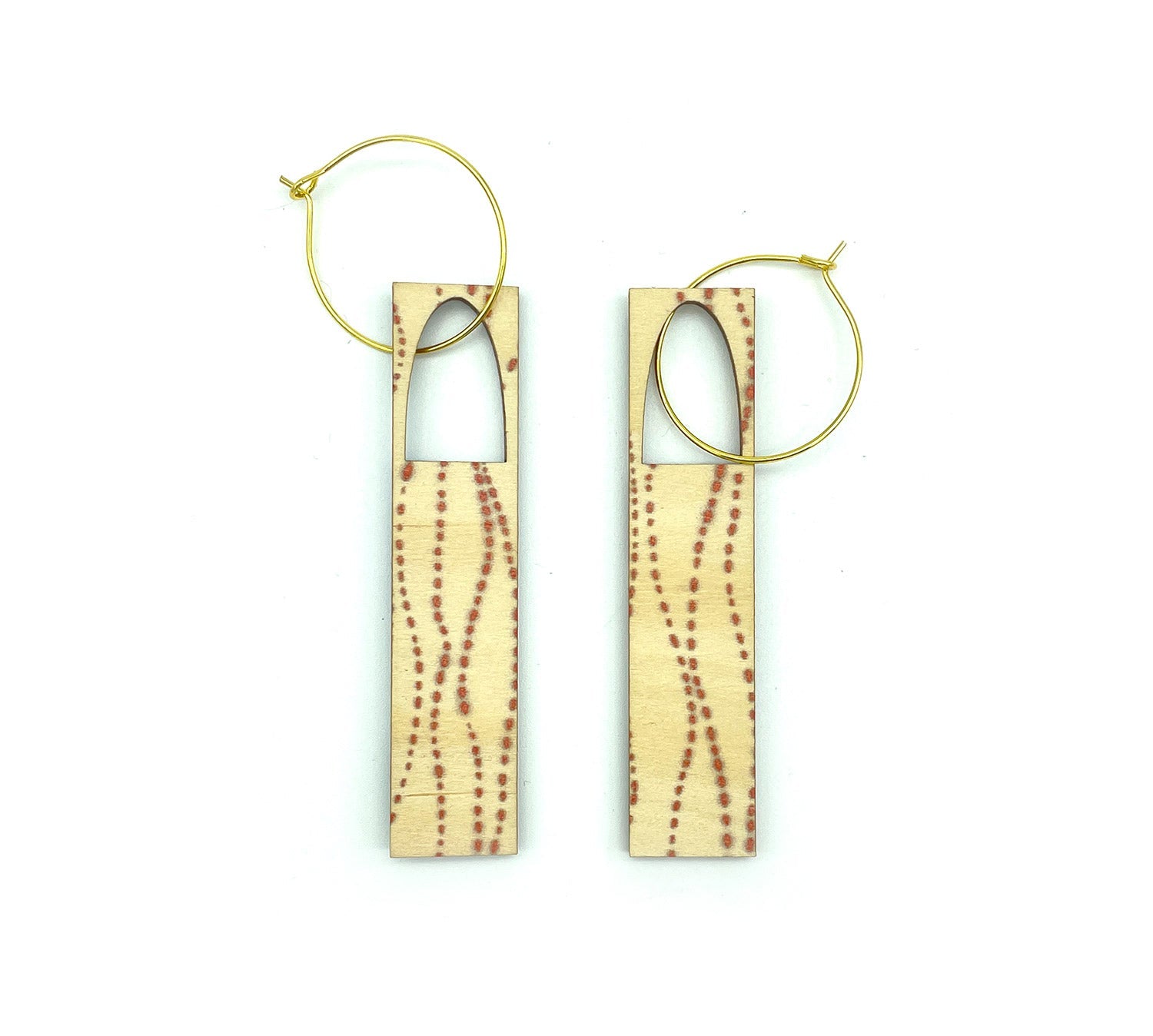 Long designer earings on gold hoops at O Gosh Shop