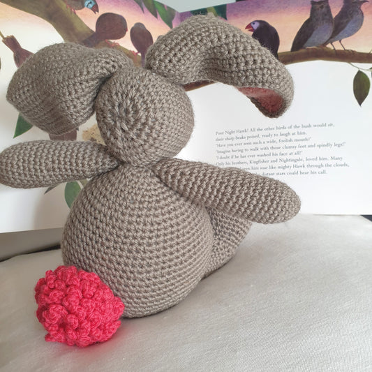 Cuddly toy rabbit with pink tail